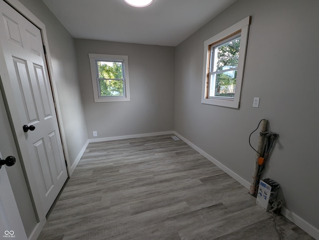 29 N State Road 29, Michigantown, IN 46057 - unfurnished bedroom featuring multiple windows and wood finished floors