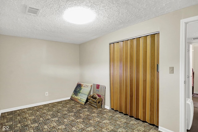 2777 S 600 E, Franklin, IN 46131 - unfurnished bedroom featuring a closet, a textured ceiling, and tile patterned floors