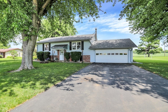 2777 S 600 E, Franklin, IN 46131 - raised ranch with brick siding, driveway, a garage, and a front yard