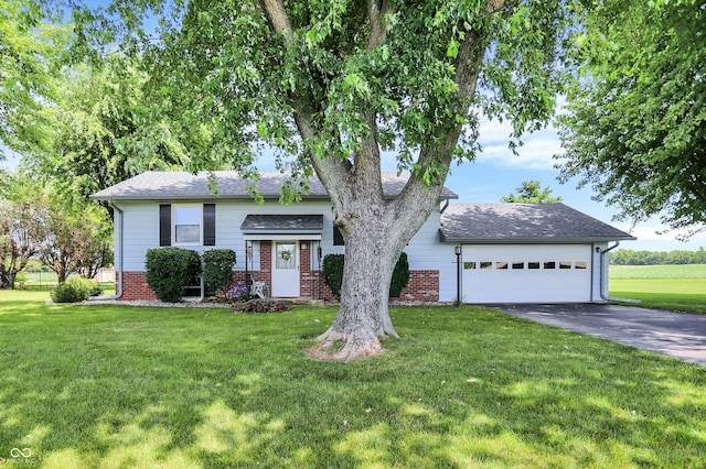2777 S 600 E, Franklin, IN 46131 - view of front of house with driveway, a front yard, brick siding, and a garage