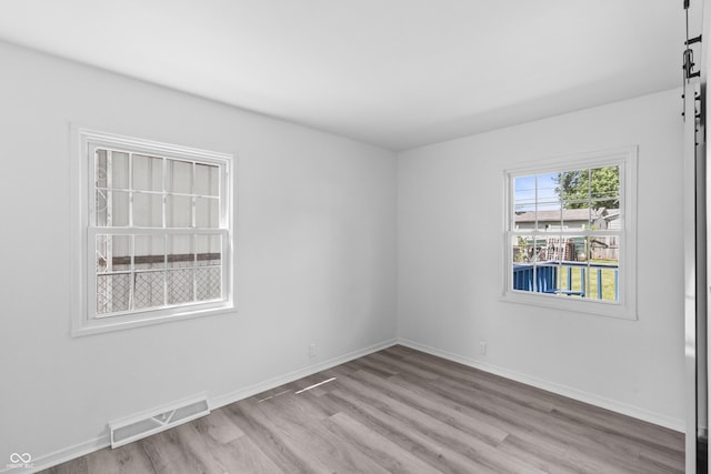 2829 Dakota Dr, Anderson, IN 46012 - empty room with wood finished floors and a barn door