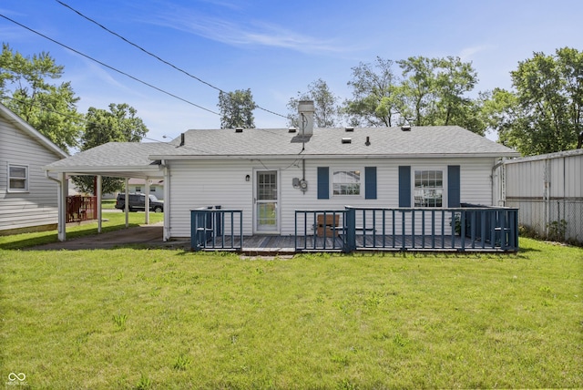 2829 Dakota Dr, Anderson, IN 46012 - rear view of property with a deck, an attached carport, a lawn, a shingled roof, and a chimney