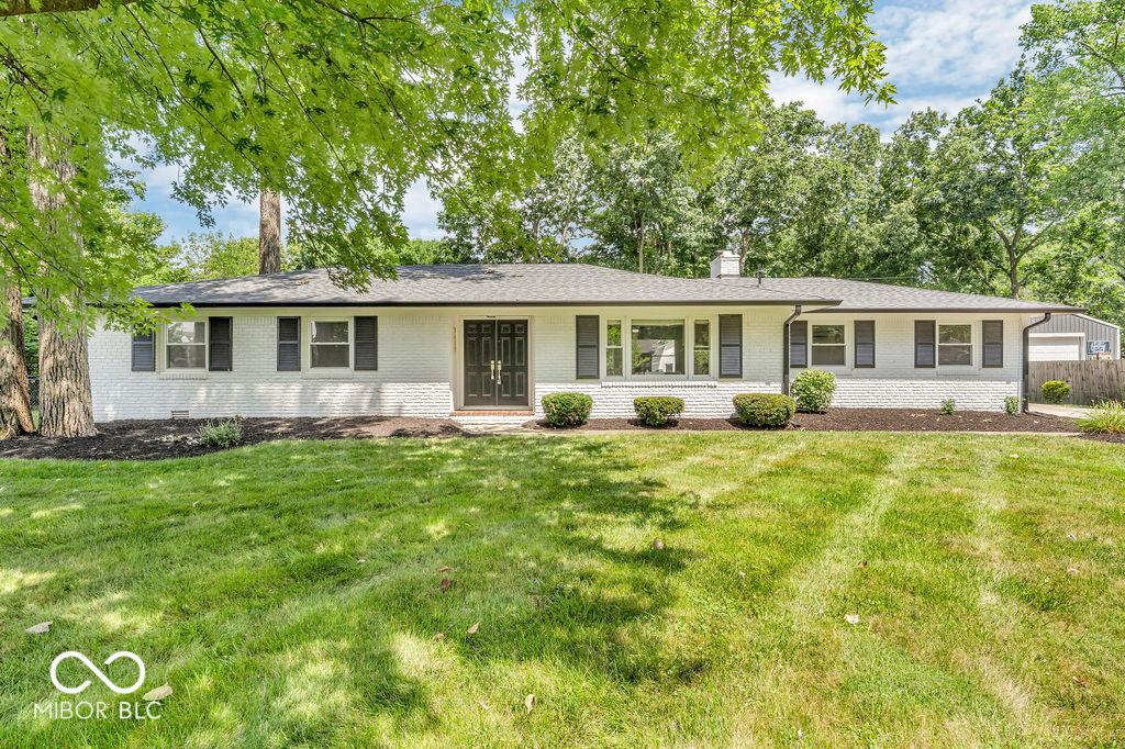 9639 Maple Dr, Carmel, IN 46280 - single story home featuring brick siding, a chimney, and a front yard