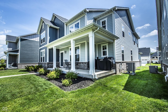 14404 Stairbridge Pl, Carmel, IN 46074 - view of home's exterior featuring board and batten siding, a porch, a yard, and stone siding