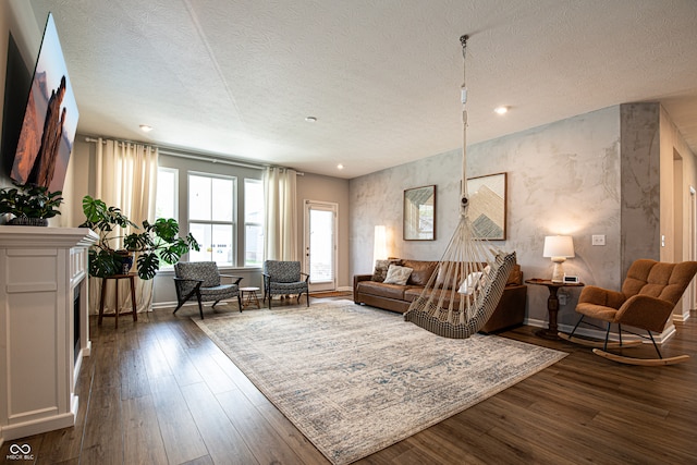 14404 Stairbridge Pl, Carmel, IN 46074 - living room with a textured ceiling, dark wood-style floors, recessed lighting, and a fireplace