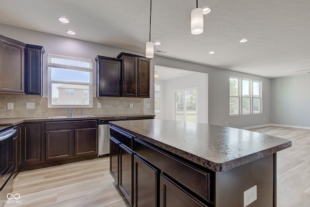 14620 Hinton Dr, Fishers, IN 46037 - kitchen with stainless steel appliances, dark countertops, light wood-style flooring, tasteful backsplash, and recessed lighting