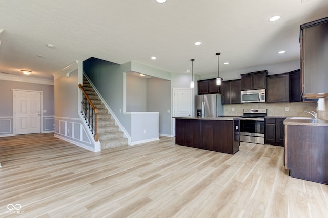 14620 Hinton Dr, Fishers, IN 46037 - kitchen featuring stainless steel appliances, a kitchen island, dark brown cabinetry, light countertops, and recessed lighting