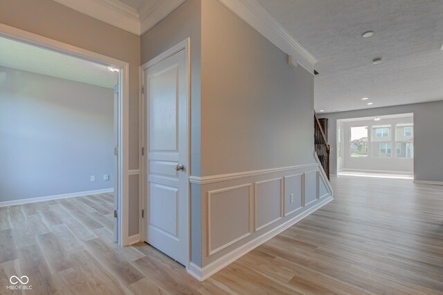 14620 Hinton Dr, Fishers, IN 46037 - hallway featuring ornamental molding, stairway, light wood-type flooring, a textured ceiling, and recessed lighting