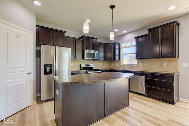 14620 Hinton Dr, Fishers, IN 46037 - kitchen with appliances with stainless steel finishes, dark brown cabinets, light wood-type flooring, and recessed lighting