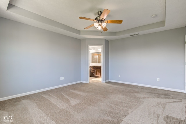 14620 Hinton Dr, Fishers, IN 46037 - spare room featuring a tray ceiling, ceiling fan, carpet floors, and a smoke detector