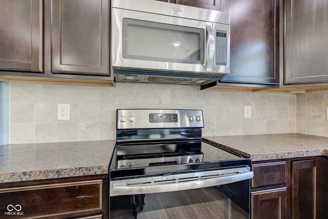 14620 Hinton Dr, Fishers, IN 46037 - kitchen with stainless steel appliances, dark brown cabinetry, and tasteful backsplash