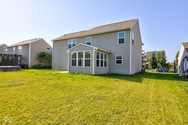 14620 Hinton Dr, Fishers, IN 46037 - rear view of property featuring a trampoline and a lawn
