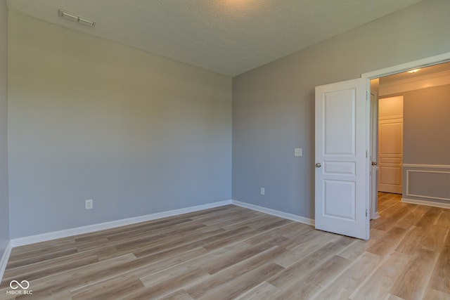 14620 Hinton Dr, Fishers, IN 46037 - empty room featuring light wood-type flooring and a textured ceiling