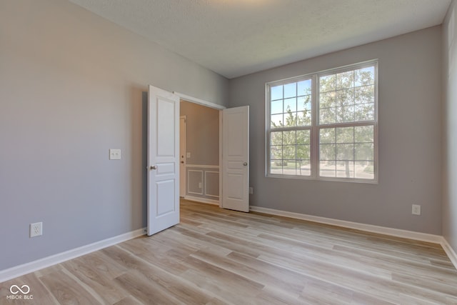 14620 Hinton Dr, Fishers, IN 46037 - unfurnished bedroom featuring light wood-style floors and a textured ceiling