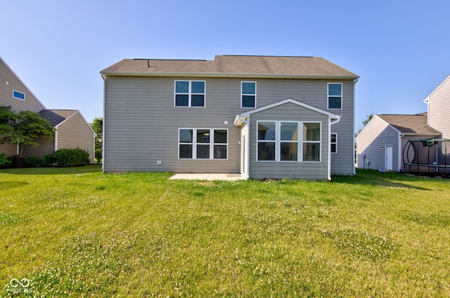 14620 Hinton Dr, Fishers, IN 46037 - rear view of house featuring a patio, a yard, and a trampoline