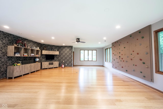 3711 Tara Ct, Carmel, IN 46074 - unfurnished living room featuring wallpapered walls, an accent wall, light wood-type flooring, a ceiling fan, and recessed lighting