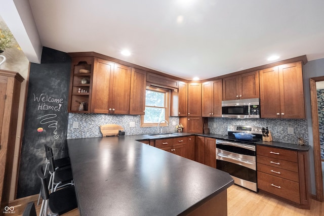 3711 Tara Ct, Carmel, IN 46074 - kitchen featuring stainless steel appliances, dark countertops, a peninsula, open shelves, and light wood finished floors