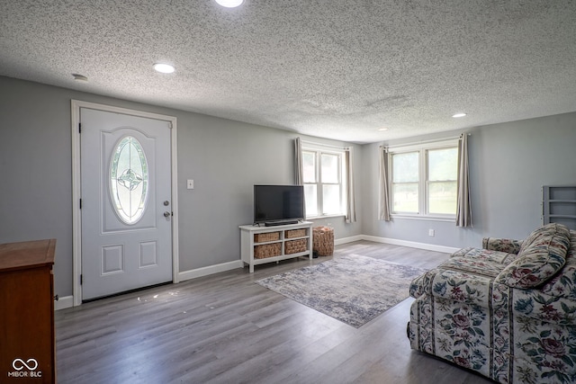 5902 Oak Ln, Anderson, IN 46013 - living area featuring wood finished floors, a textured ceiling, and recessed lighting