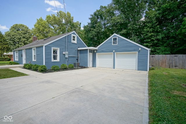 5902 Oak Ln, Anderson, IN 46013 - ranch-style home featuring an outbuilding, a garage, and a chimney