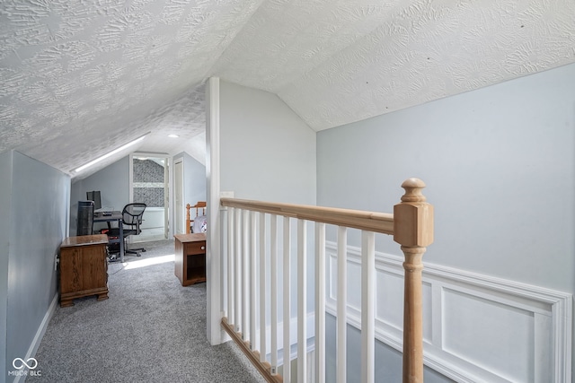 5902 Oak Ln, Anderson, IN 46013 - corridor featuring vaulted ceiling, an upstairs landing, a textured ceiling, carpet, and a desk