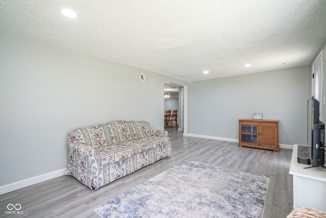 5902 Oak Ln, Anderson, IN 46013 - living area with a textured ceiling, wood finished floors, and recessed lighting