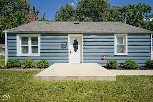 5902 Oak Ln, Anderson, IN 46013 - view of front of property featuring a front yard, a chimney, and roof with shingles