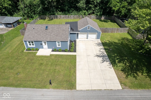 5902 Oak Ln, Anderson, IN 46013 - view of front of house featuring concrete driveway, roof with shingles, an outdoor structure, and a fenced backyard