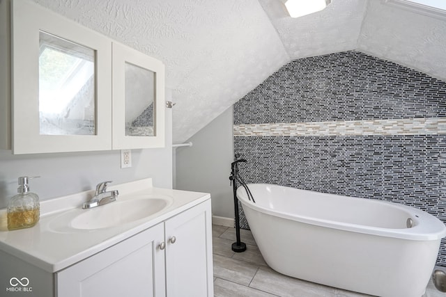 5902 Oak Ln, Anderson, IN 46013 - full bathroom featuring a textured ceiling, vanity, a soaking tub, lofted ceiling, and wood finished floors