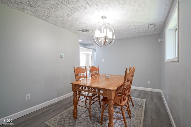 5902 Oak Ln, Anderson, IN 46013 - dining area featuring a chandelier, a textured ceiling, and wood finished floors