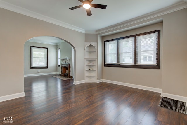 4155 Graceland Ave, Indianapolis, IN 46208 - unfurnished living room with arched walkways, ceiling fan, wood finished floors, ornamental molding, and built in features