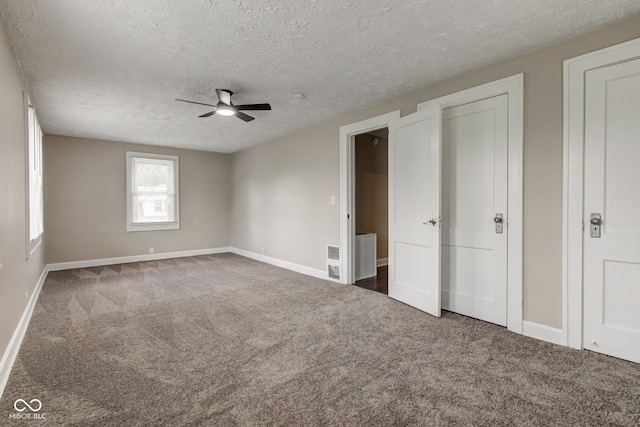 4155 Graceland Ave, Indianapolis, IN 46208 - unfurnished bedroom featuring carpet, a textured ceiling, and ceiling fan