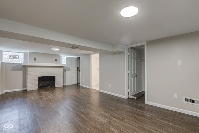 4155 Graceland Ave, Indianapolis, IN 46208 - unfurnished living room with dark wood finished floors, a brick fireplace, and healthy amount of natural light