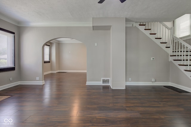 4155 Graceland Ave, Indianapolis, IN 46208 - unfurnished living room with arched walkways, a textured ceiling, healthy amount of natural light, a ceiling fan, and wood finished floors