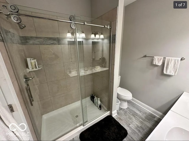 4155 Graceland Ave, Indianapolis, IN 46208 - bathroom featuring a stall shower, wood finished floors, and vanity