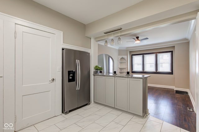 4155 Graceland Ave, Indianapolis, IN 46208 - kitchen with stainless steel fridge, a peninsula, a ceiling fan, ornamental molding, and pendant lighting