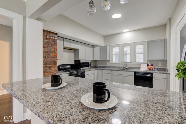 4155 Graceland Ave, Indianapolis, IN 46208 - kitchen featuring black appliances, light stone countertops, and dark wood-style flooring