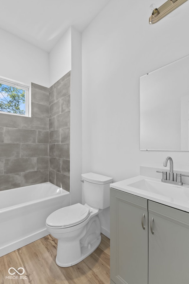 2709 Station St, Indianapolis, IN 46218 - full bath with vanity, wood finished floors, and shower / tub combination