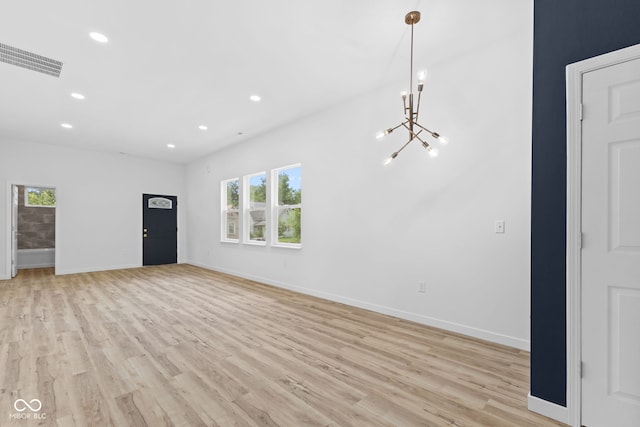 2709 Station St, Indianapolis, IN 46218 - unfurnished living room with a chandelier, light wood finished floors, and recessed lighting
