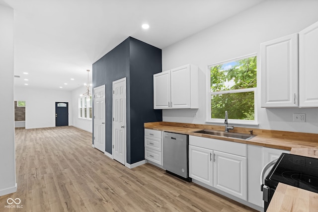 2709 Station St, Indianapolis, IN 46218 - kitchen with butcher block countertops, dishwasher, a chandelier, white cabinets, and recessed lighting