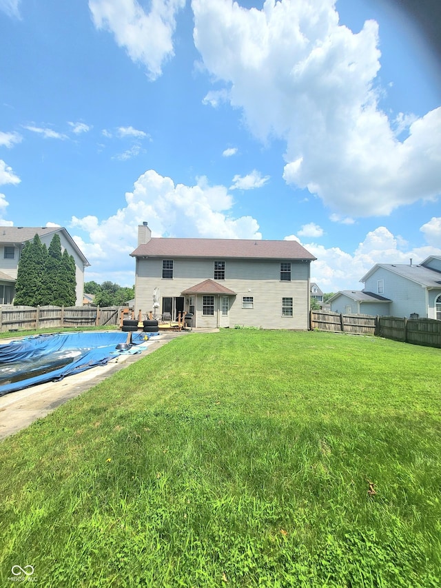 430 N Greenbriar Dr, Greenwood, IN 46142 - back of house featuring a chimney and a patio