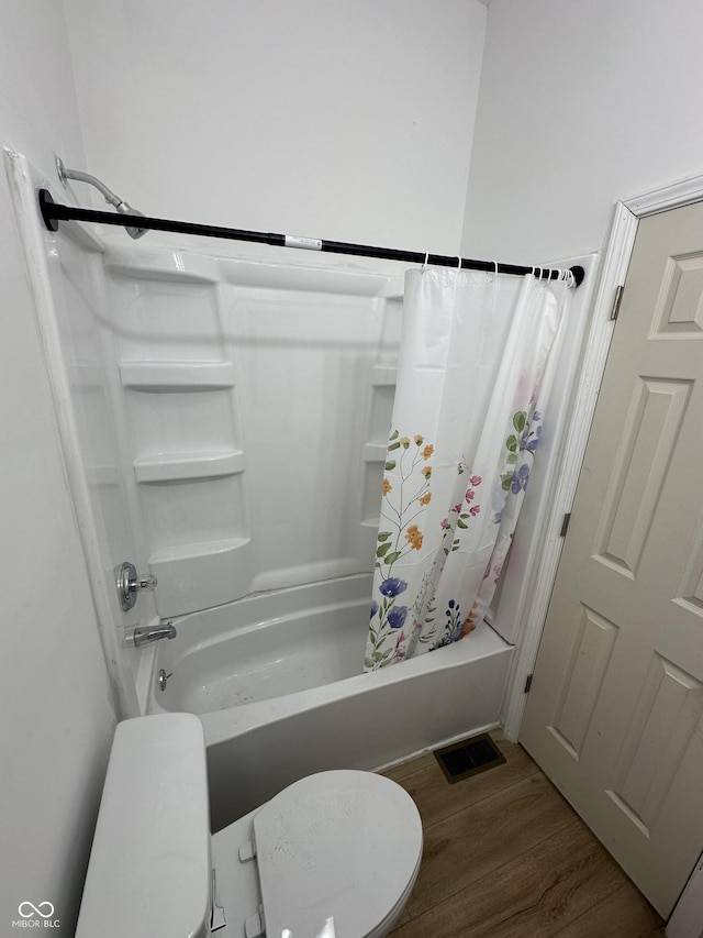 1256 Kappes St, Indianapolis, IN 46221 - bathroom featuring shower / bath combination with curtain and wood finished floors