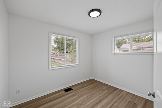 1730 S State Ave, Indianapolis, IN 46203 - spare room featuring plenty of natural light and wood finished floors