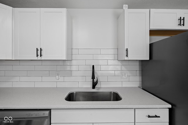 1730 S State Ave, Indianapolis, IN 46203 - kitchen featuring dishwasher, decorative backsplash, white cabinets, and light stone countertops