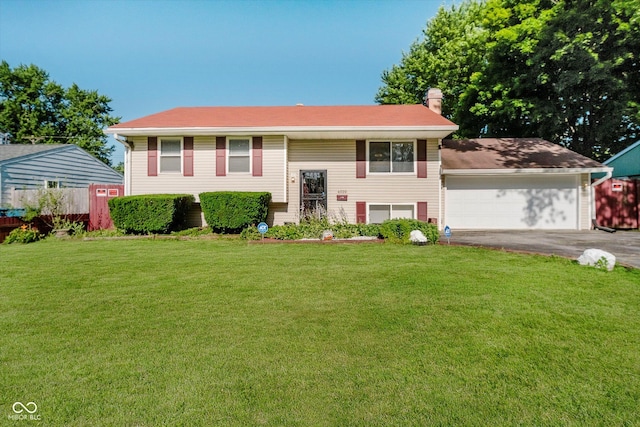 4020 Eisenhower Dr, Indianapolis, IN 46254 - raised ranch featuring a chimney, asphalt driveway, and a garage
