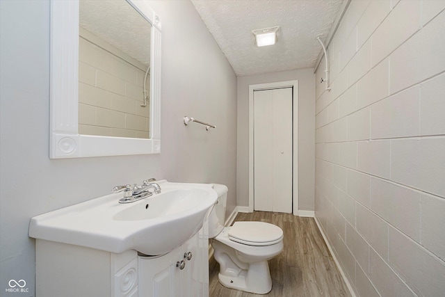 4020 Eisenhower Dr, Indianapolis, IN 46254 - bathroom featuring wood finished floors, a textured ceiling, and vanity
