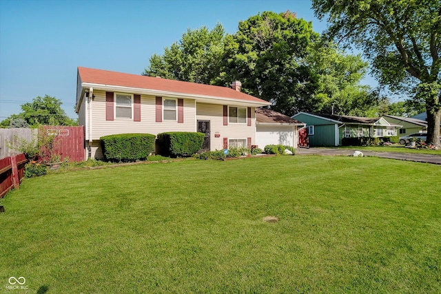 4020 Eisenhower Dr, Indianapolis, IN 46254 - split foyer home featuring asphalt driveway and a garage