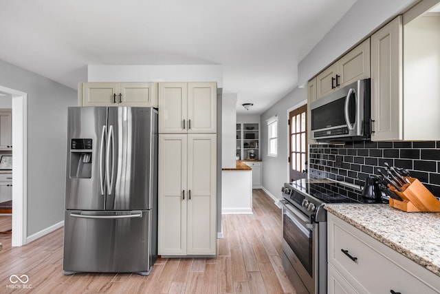 10198 N State Road 75, North Salem, IN 46165 - kitchen with appliances with stainless steel finishes, light wood-style floors, decorative backsplash, and light stone countertops