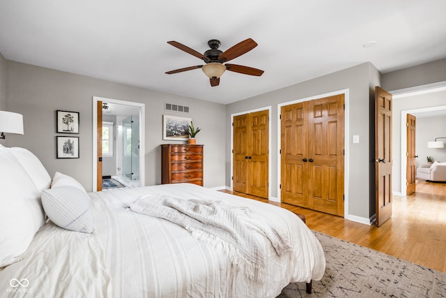 10198 N State Road 75, North Salem, IN 46165 - bedroom with wood finished floors, multiple closets, a ceiling fan, and ensuite bath