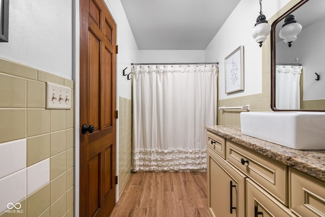 10198 N State Road 75, North Salem, IN 46165 - full bathroom with tile walls, vanity, wainscoting, wood finished floors, and a shower with curtain