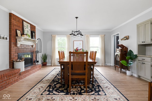 10198 N State Road 75, North Salem, IN 46165 - dining space featuring a chandelier, light wood-style flooring, crown molding, and a fireplace